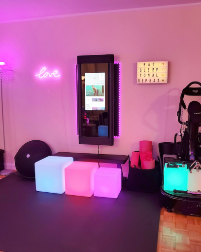 Home gym design with Tonal and bright lights
