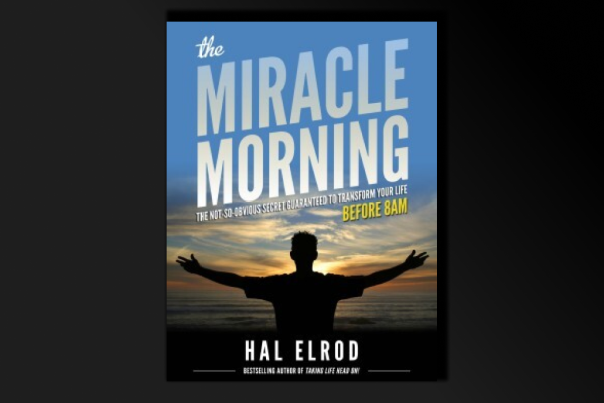 book cover art with the title: Miracle Morning and the image of a man holding up his arms towards the sun rising over the horizon. 