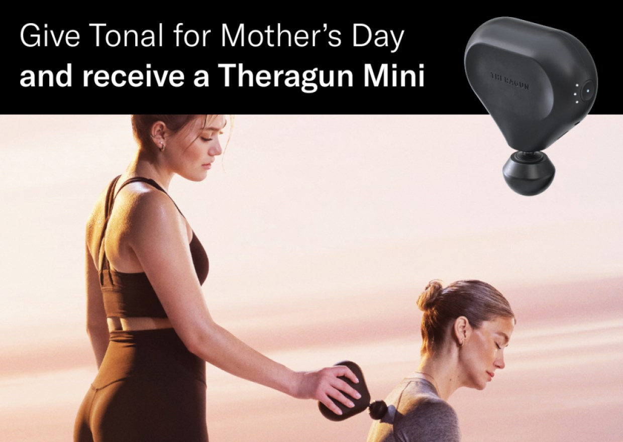 a woman uses a Theragun mini massage device on another woman's shoulder and the text: Give Tonal for Mother's Day and receive a Theragun Mini