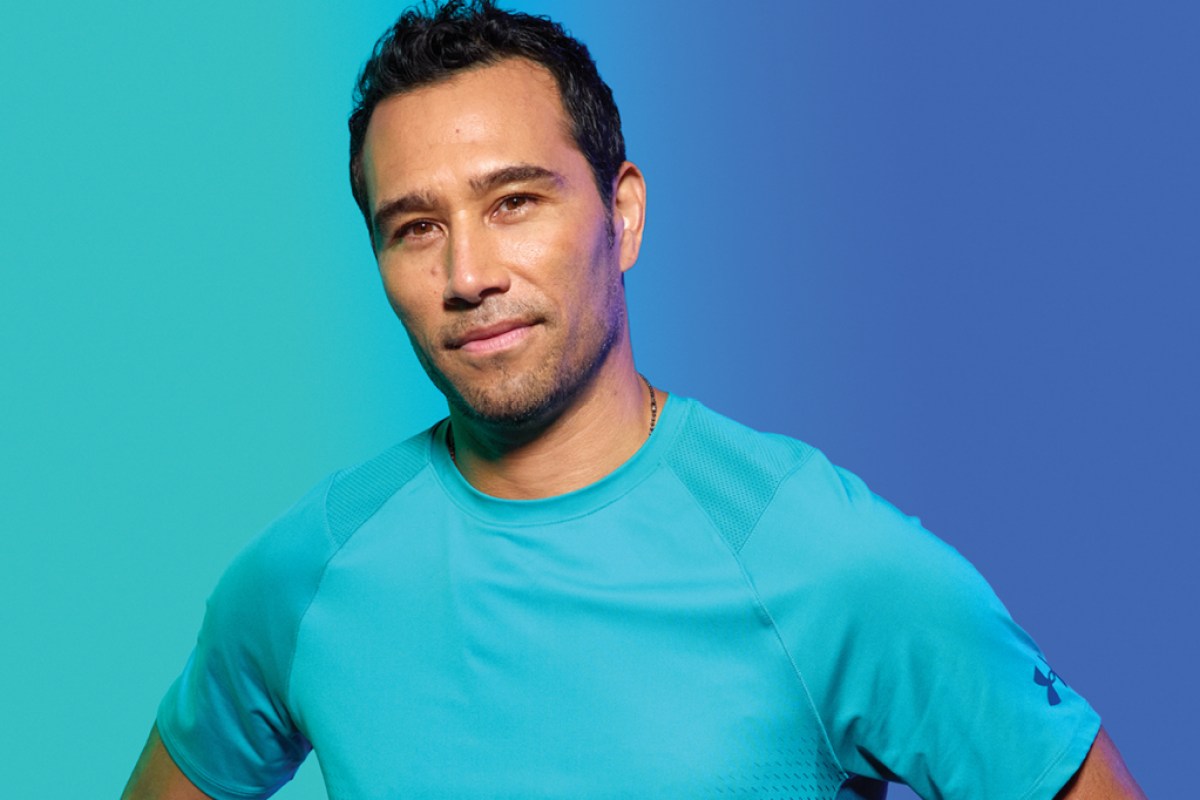 a man wearing a blue t-shirt on a graphic blue background