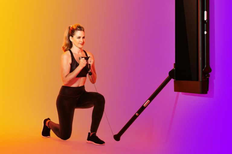 woman doing a goblet reverse lunge on Tonal to illustrate strength training for hiking