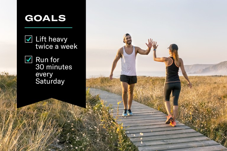 how to set goals you can actually achieve - image of two people high fiving with a list of goals