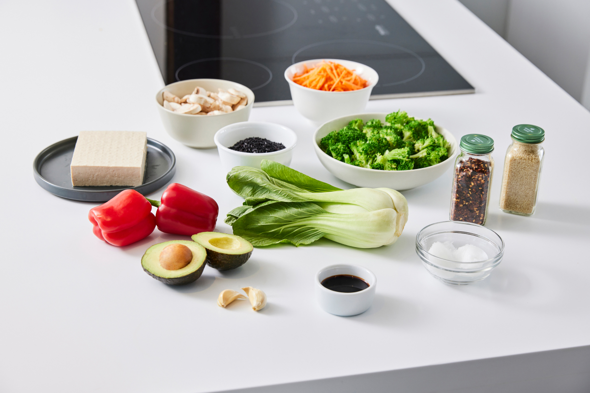 a selection of colorful veggies, spices and other ingredients needed for a healthy tofu recipe