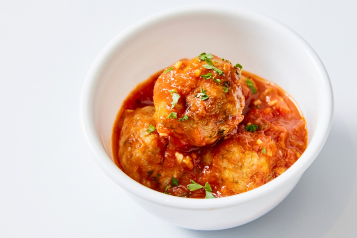 a bowl of turkey meatballs covered in a tomato sauce