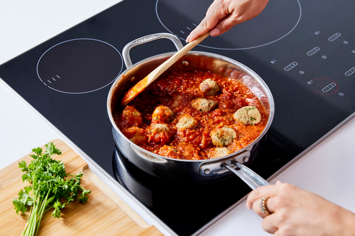 Image of a skillet with sauce and meatballs in it demonstrating a turkey meatball recipe