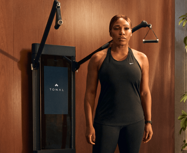 Serena Williams posing with Tonal to highlight her new partnership.