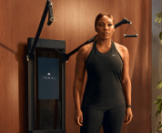 Serena Williams standing strong in front of Tonal. 