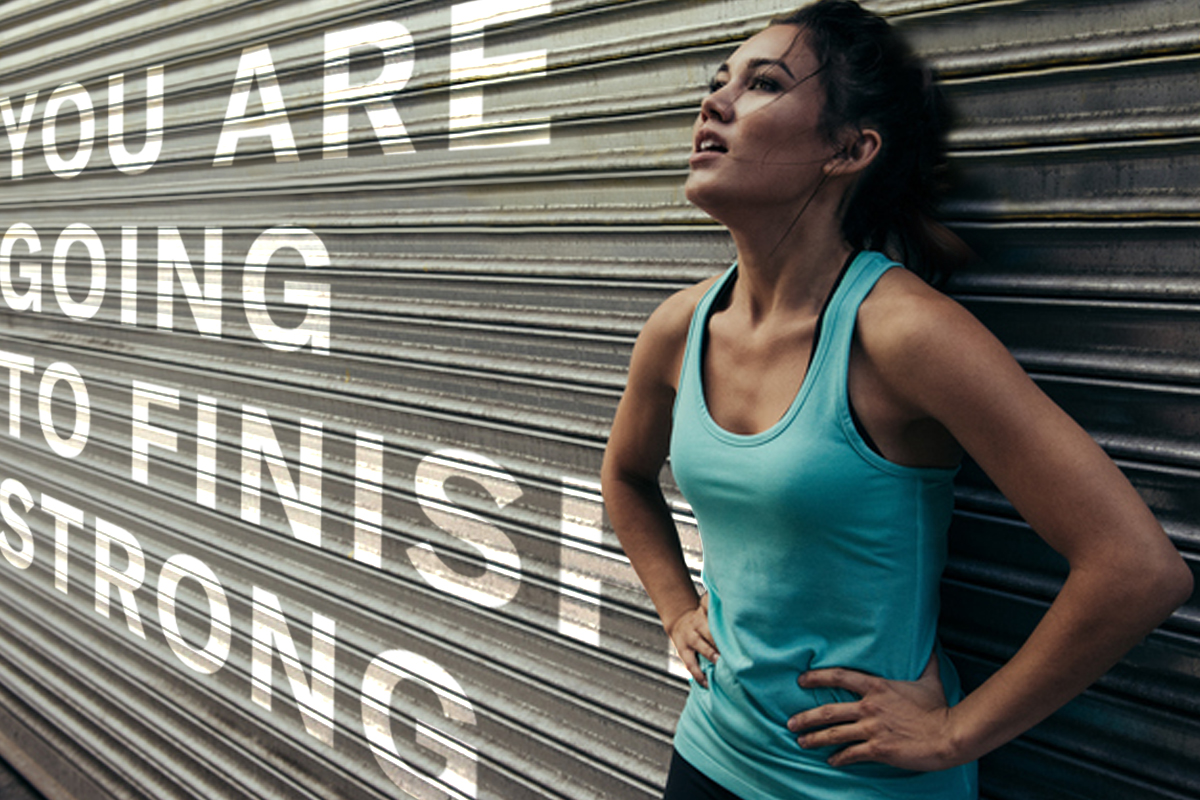 Woman in workout clothes leaning against a wall with motivational phrase superimposed: "You are going to finish strong." 