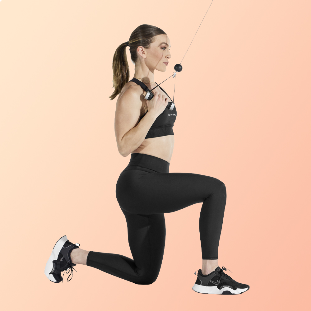 image of woman performing a half-kneeling single arm lat pull-down for postpartum exercises 