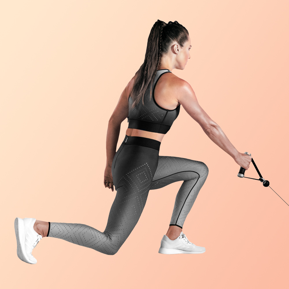 image of woman performing a reverse lunge with row for postpartum exercises 