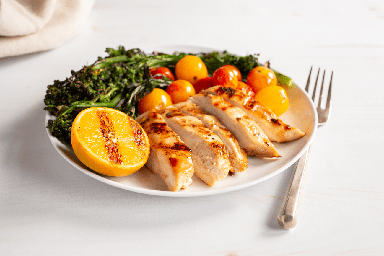 Citrus-marinated chicken with grilled broccolini and tomatoes