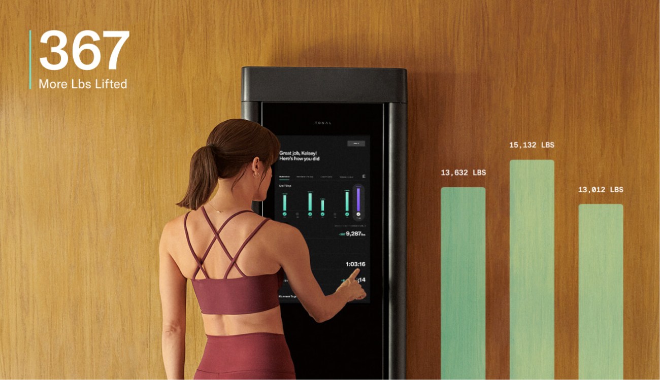 An image of a woman selecting a workout from the Tonal home screen.