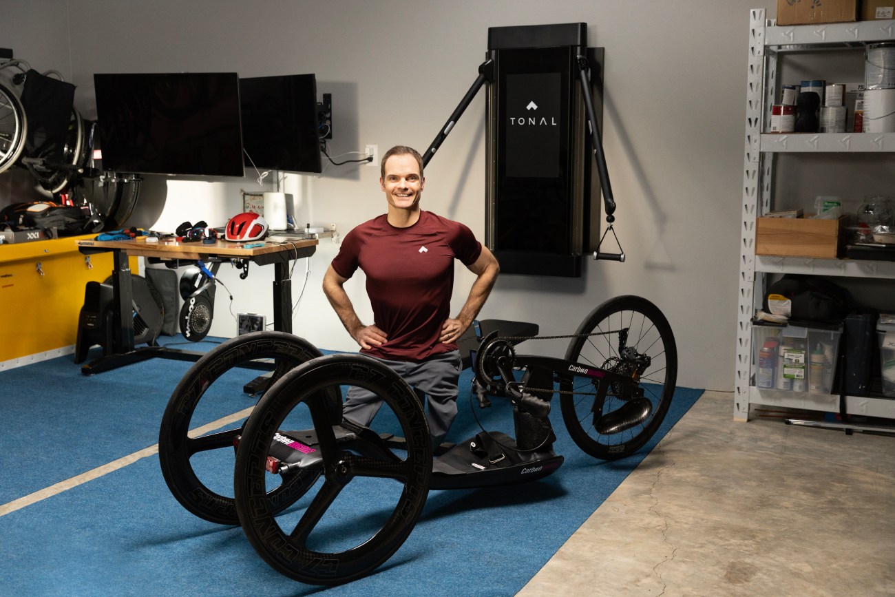 Professional cyclist Travis Gaertner with his handcycle bike and Tonal. 