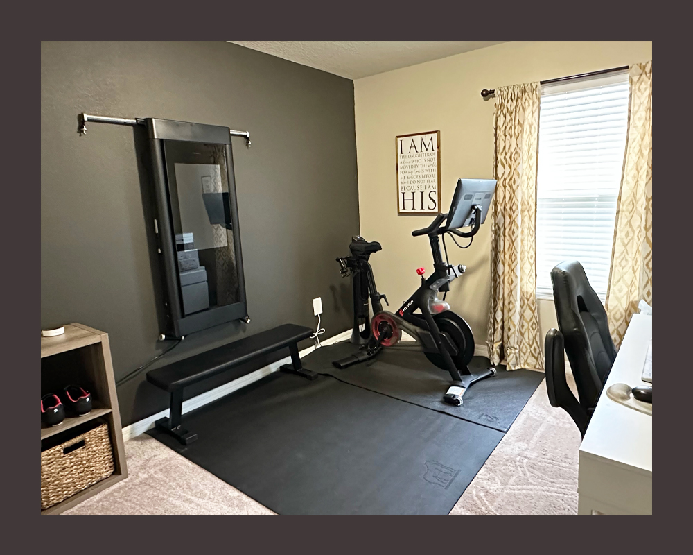 Tonal and an exercise bike in a member's home gym office combo.