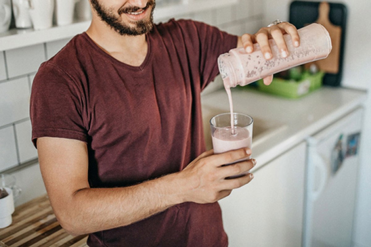 Man pouring a protein shake